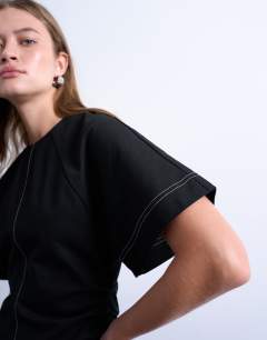 Model wearing Heavy twill contrast stitch short sleeve mini dress in black