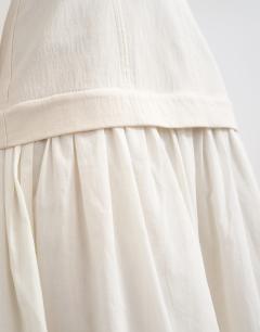 Model wearing Heavy twill dropped waist maxi dress with full skirt in natural