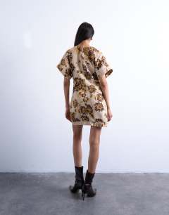 Model wearing Heavy twill structured mini dress in yellow winding floral