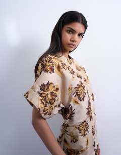 Model wearing Heavy twill structured mini dress in yellow winding floral