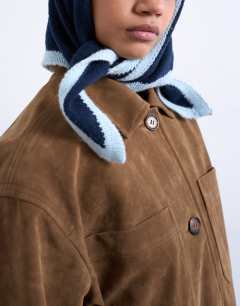 Model wearing Heidi knitted headscarf in navy & light blue