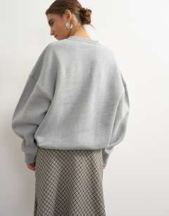 Model wearing Henley button detail sweat in grey marl