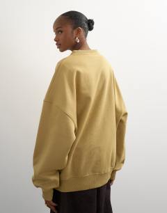 Model wearing Henley button detail sweat in soft khaki
