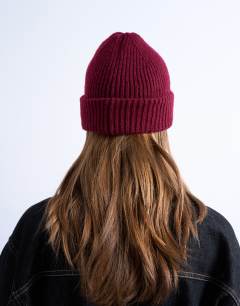 Model wearing Henry ribbed beanie in burgundy