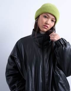 Model wearing Henry ribbed beanie in green