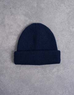 Model wearing Henry ribbed beanie in navy