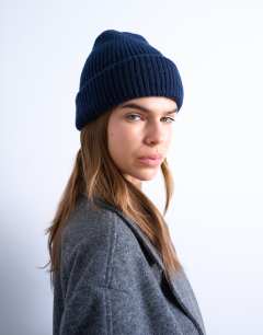 Model wearing Henry ribbed beanie in navy