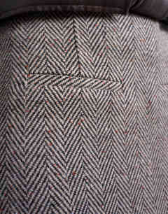 Model wearing Herringbone mini pelmet skirt in mono