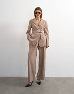 Model wearing High break belted blazer in beige