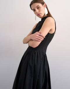 Model wearing High neck asymmetric waist bubble hem maxi dress in black