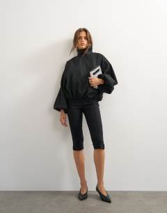 Model wearing High neck balloon hem top in black