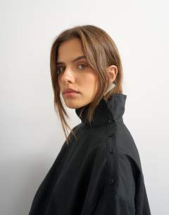 Model wearing High neck balloon hem top in black
