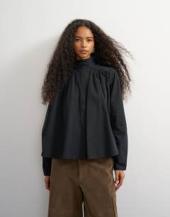Model wearing High neck balloon sleeve shirt in black