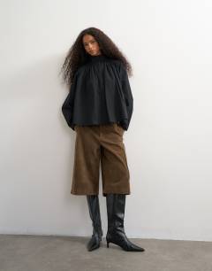 Model wearing High neck balloon sleeve shirt in black