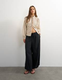 Model wearing High neck balloon sleeve shirt in neutral stripe