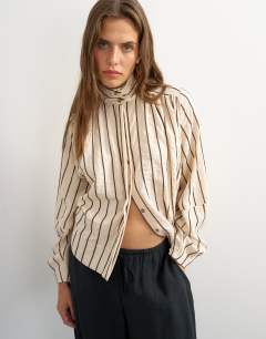 Model wearing High neck balloon sleeve shirt in neutral stripe