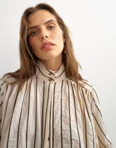 Model wearing High neck balloon sleeve shirt in neutral stripe