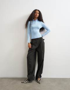 Model wearing High neck button rib long sleeve top in light blue