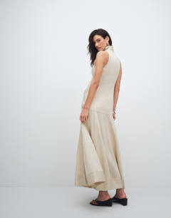 Model wearing High neck dropped waist maxi dress in natural stripe