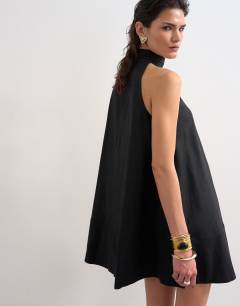 Model wearing High neck linen rich trapeze dress in black