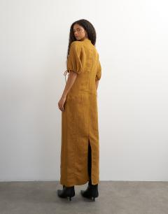 Model wearing High neck maxi dress with puff toggle sleeve in brown woven stripe