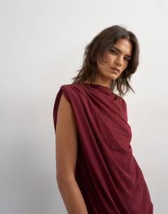 Model wearing High neck mesh draped mini dress in burgundy