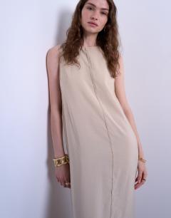 Model wearing High neck open back chuck on cupro midi dress in buttermilk