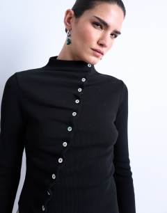 Model wearing High neck ruffle button long sleeve top in black