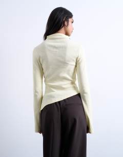 Model wearing High neck ruffle button long sleeve top in buttermilk