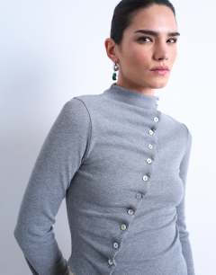 Model wearing High neck ruffle button long sleeve top in grey marl