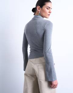Model wearing High neck ruffle button long sleeve top in grey marl