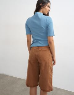 Model wearing High neck ruffle button through half sleeve top in dusty blue