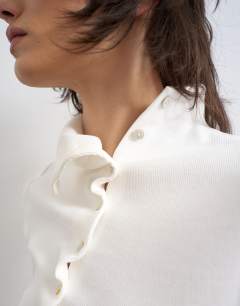 Model wearing High neck ruffle button through half sleeve top in ecru