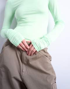Model wearing High neck viscose long sleeve top in mint geen
