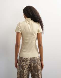 Model wearing High neck zip through short sleeve rib top in cream