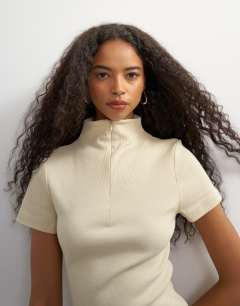 Model wearing High neck zip through short sleeve rib top in cream