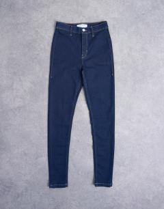 Model wearing High rise skinny jean in indigo rinse