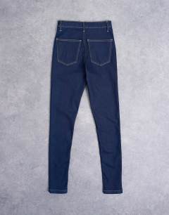 Model wearing High rise skinny jean in indigo rinse