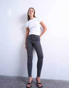 Model wearing High rise skinny jean in washed black