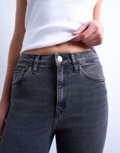 Model wearing High rise skinny jean in washed black