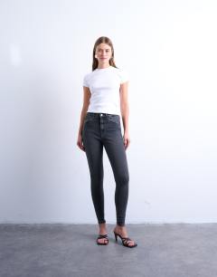 Model wearing High rise skinny jean in washed black
