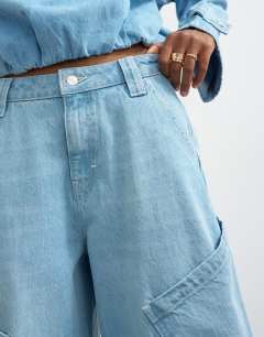 Model wearing High rise utility barrel jean in bleach