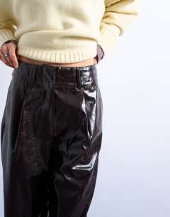Model wearing High shine high waist faux leather pleated straight leg trouser  in brown