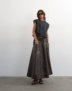 Model wearing High shine leather look maxii skirt with side pockets in washed brown