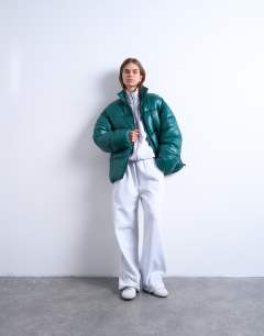 Model wearing High shine mid length puffer jacket in teal
