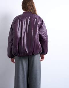 Model wearing High shine padded bomber jacket in aubergine