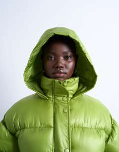Model wearing High shine ripstop puffer jacket in bright green