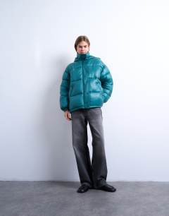 Model wearing High shine ripstop puffer jacket in teal