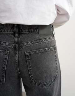 Model wearing Horizon mid rise wide leg jean in washed black