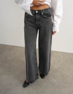 Model wearing Horizon mid rise wide leg jean in washed black
